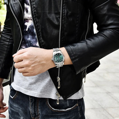 Person wearing green dial silver bracelet watch with leather jacket