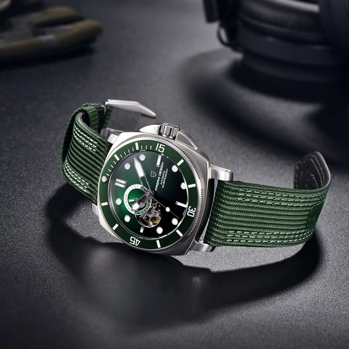 Angled view of green dial wristwatch on dark surface