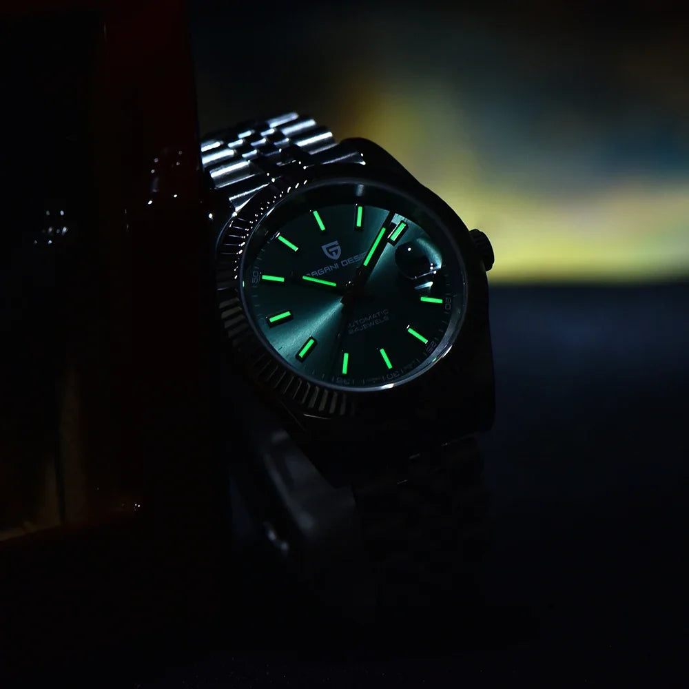 Green dial silver bracelet watch glowing in dark setting