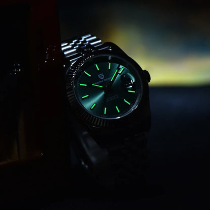 Green dial silver bracelet watch glowing in dark setting