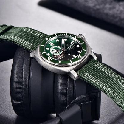 Green dial wristwatch resting on headphones